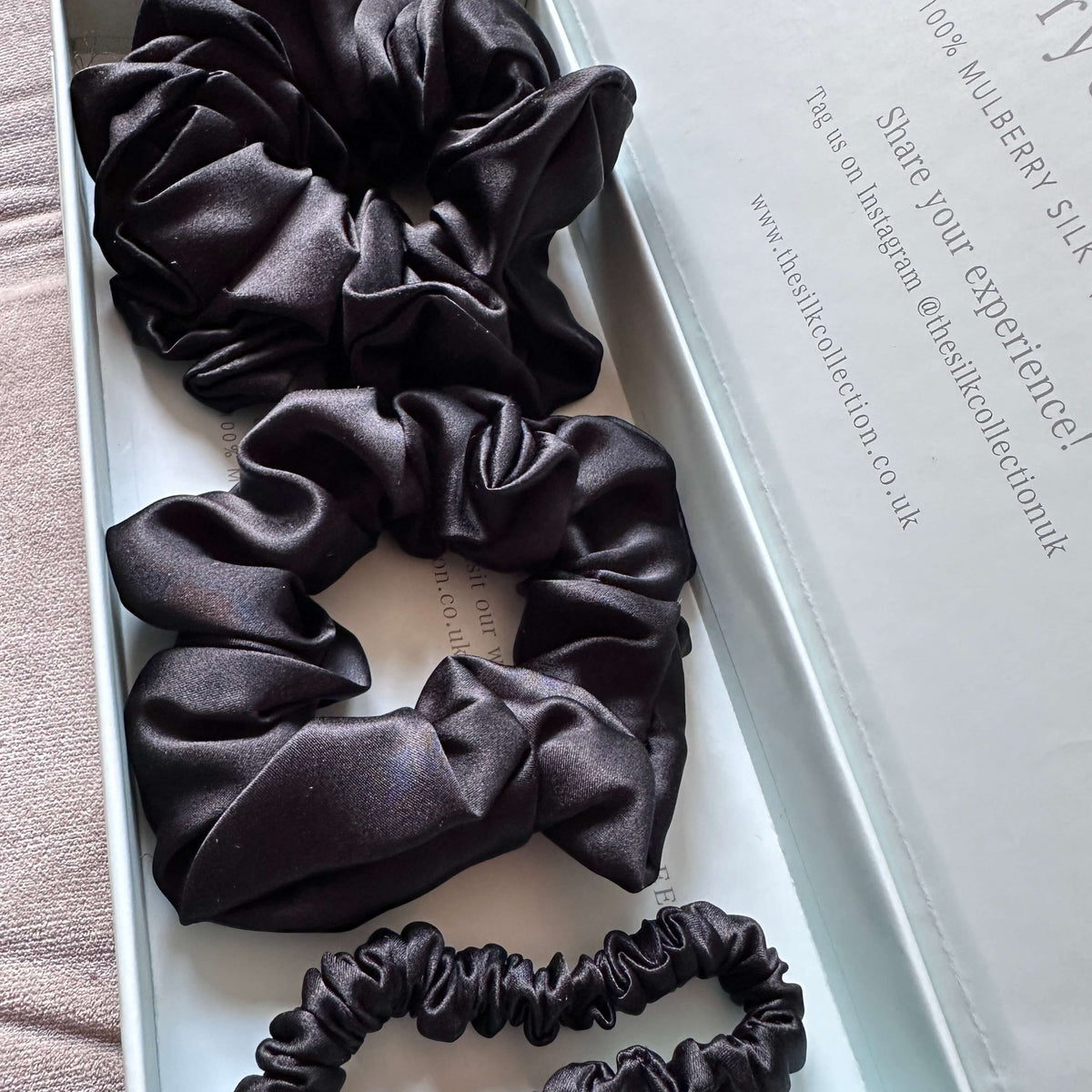 Eclipse black silk scrunchie starter set in its gift box: classic silk scrunchies and silk hair ties
