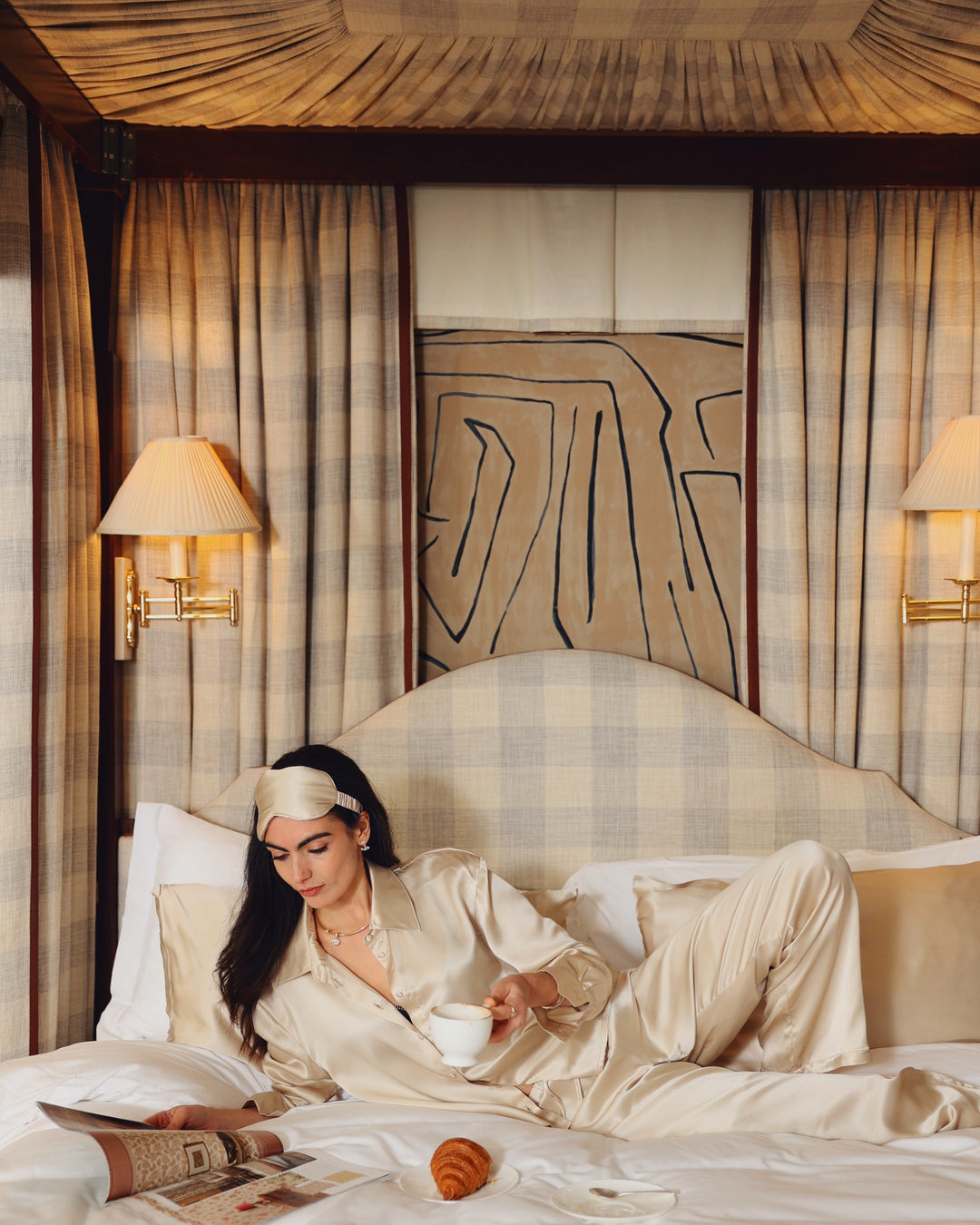 Champagne silk eye mask on head reclining four-poster wide