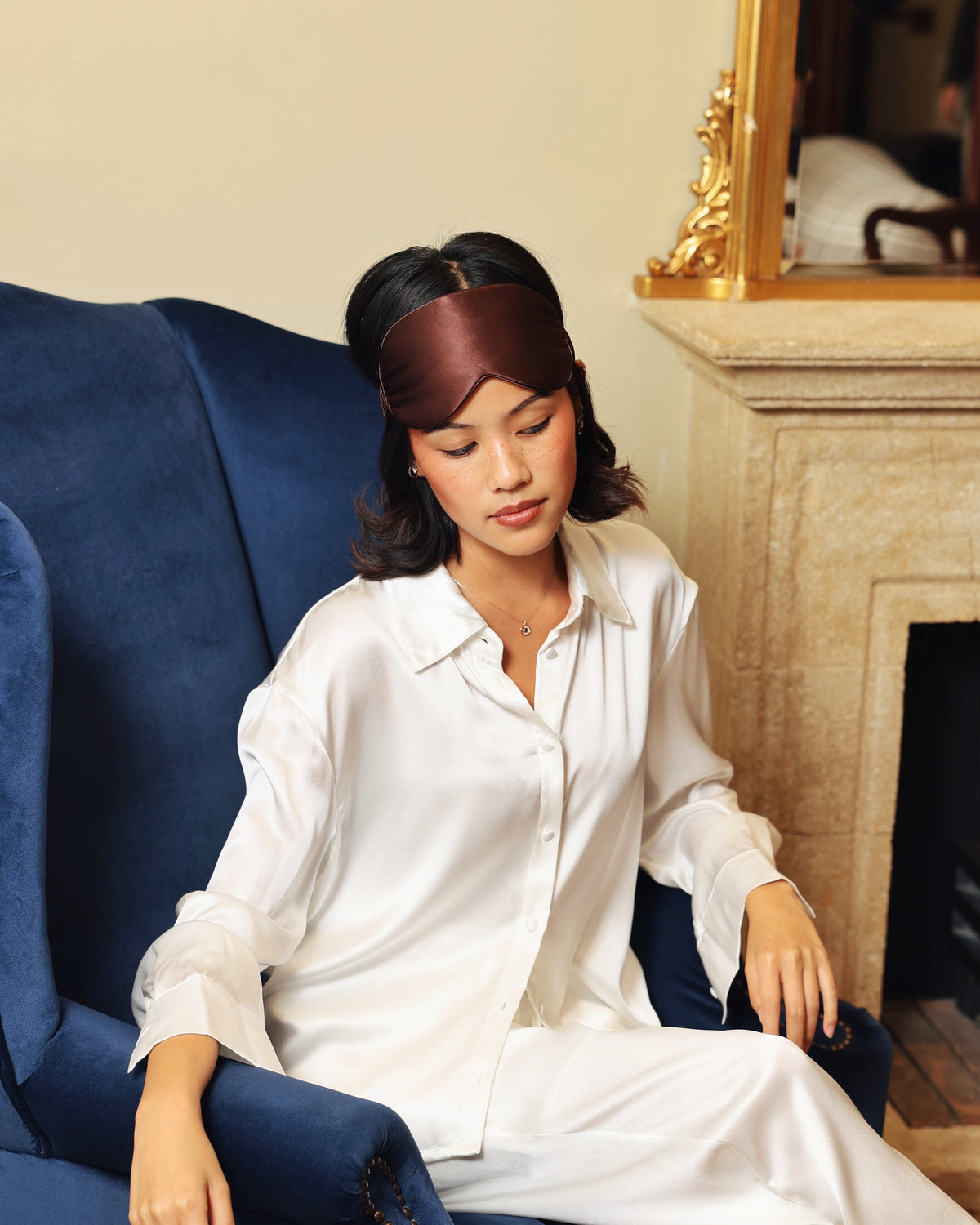 Espresso silk eye mask on head pearl white pyjamas armchair