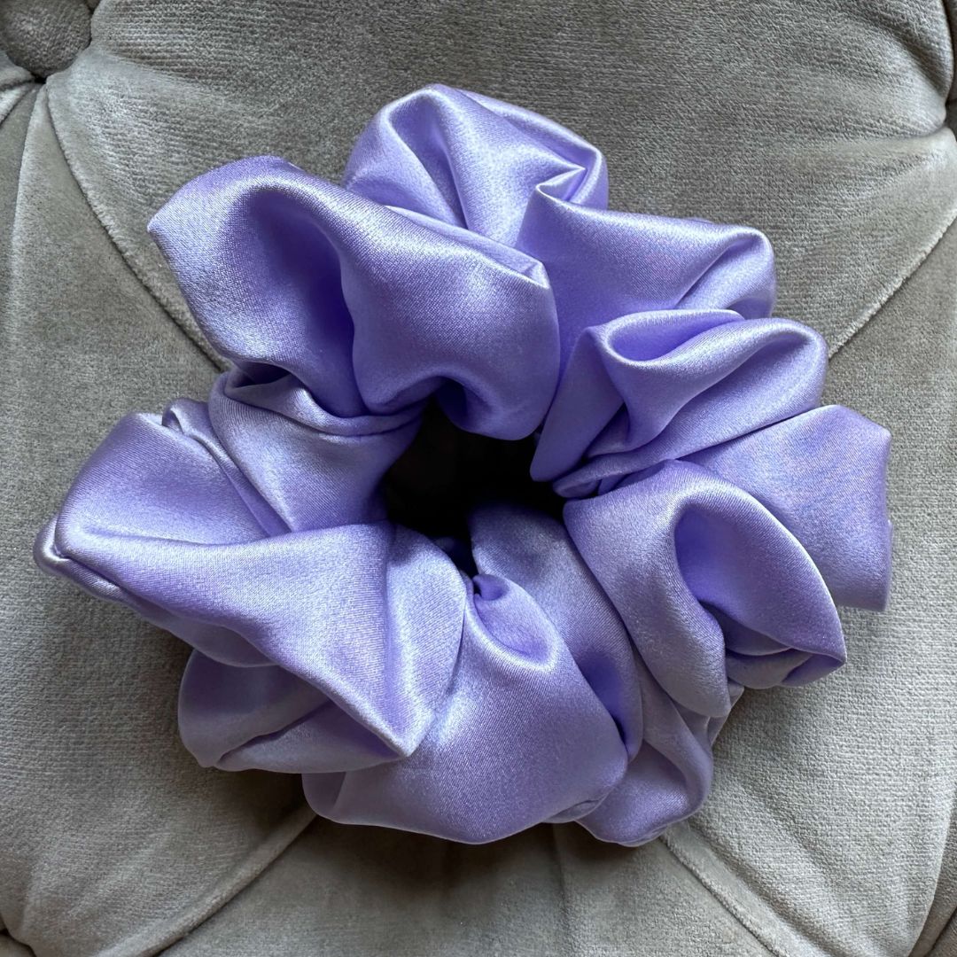 Lilac statement silk scrunchie on a velvet sofa, oversized 100% mulberry silk