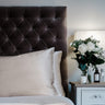 Champagne mulberry silk pillowcases for hair and skin, 22 momme 100% silk, on a velvet headboard | The Silk Collection