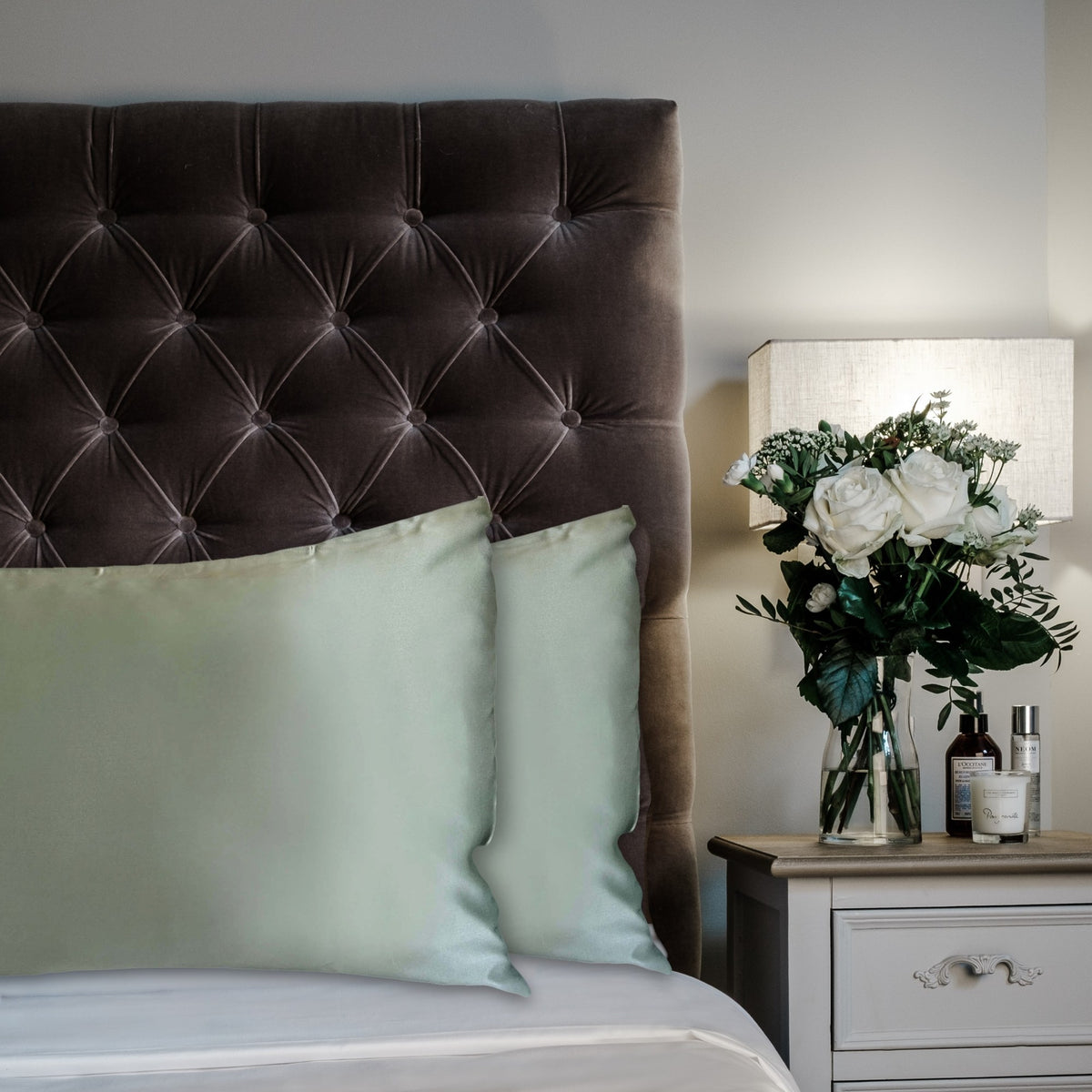 Duck Egg Blue mulberry silk pillowcases for hair and skin, 22 momme 100% silk, on a velvet headboard | The Silk Collection