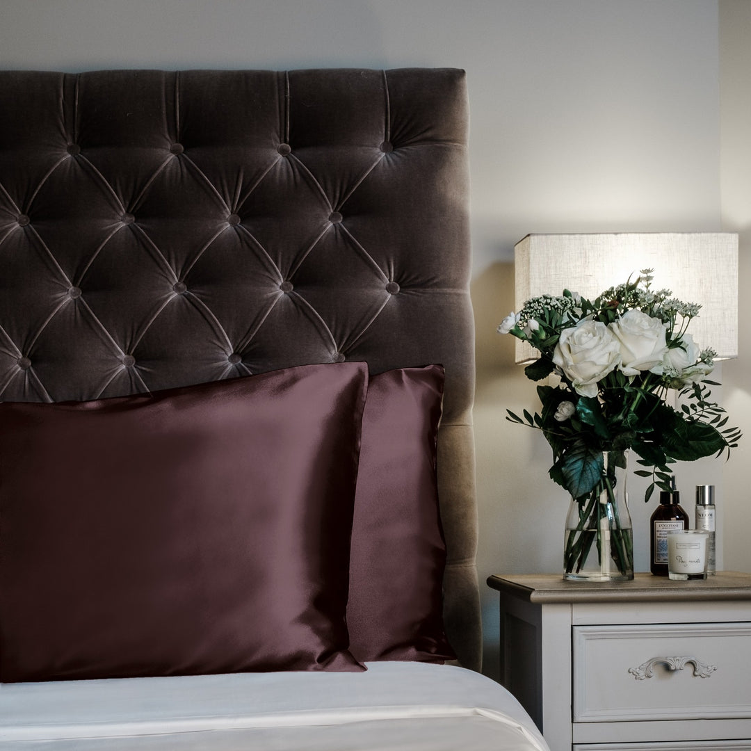 Espresso limited edition mulberry silk pillowcases, 22 momme 100% silk, on a velvet headboard | The Silk Collection