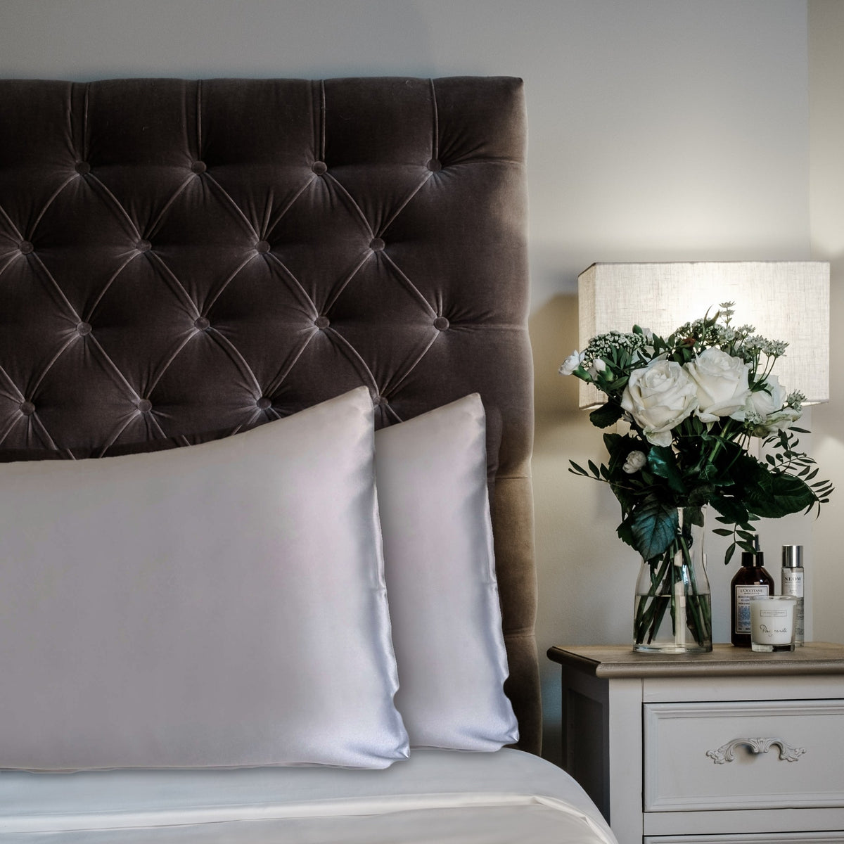 Steel Blue mulberry silk pillowcases for hair and skin, 22 momme 100% silk, on a velvet headboard | The Silk Collection