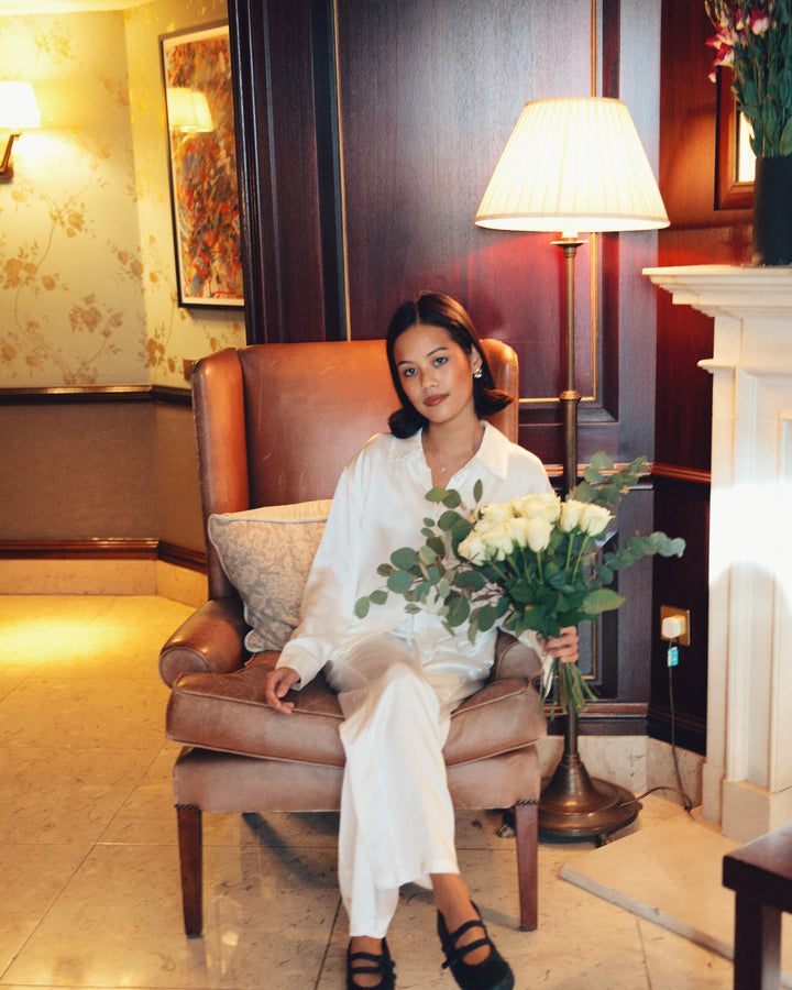 Pearl white silk pyjama set white roses leather armchair lobby
